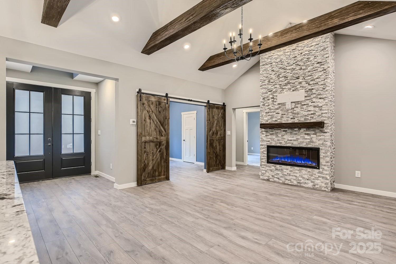 825 Potneck Road Salisbury, NC 28147 - Photo 19 of 40 a view of empty room with wooden floor and fireplace