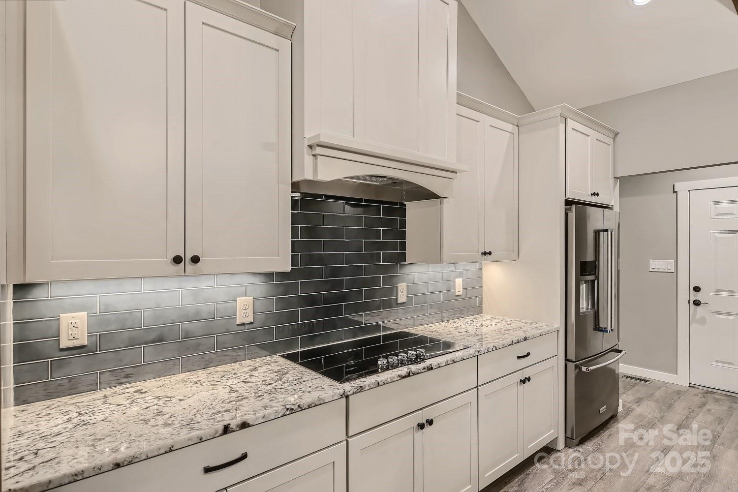 825 Potneck Road Salisbury, NC 28147 - Photo 8 of 40 a kitchen with granite countertop a sink stove and refrigerator