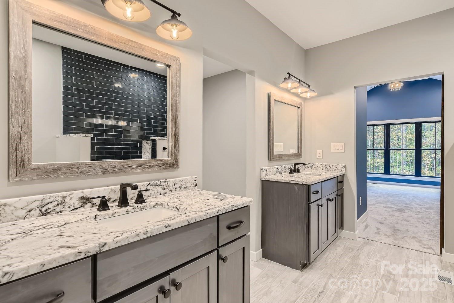 825 Potneck Road Salisbury, NC 28147 - Photo 10 of 40 a bathroom with a granite countertop sink and large mirror