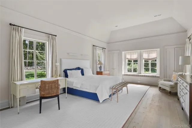 a spacious bedroom with a bed and a couch