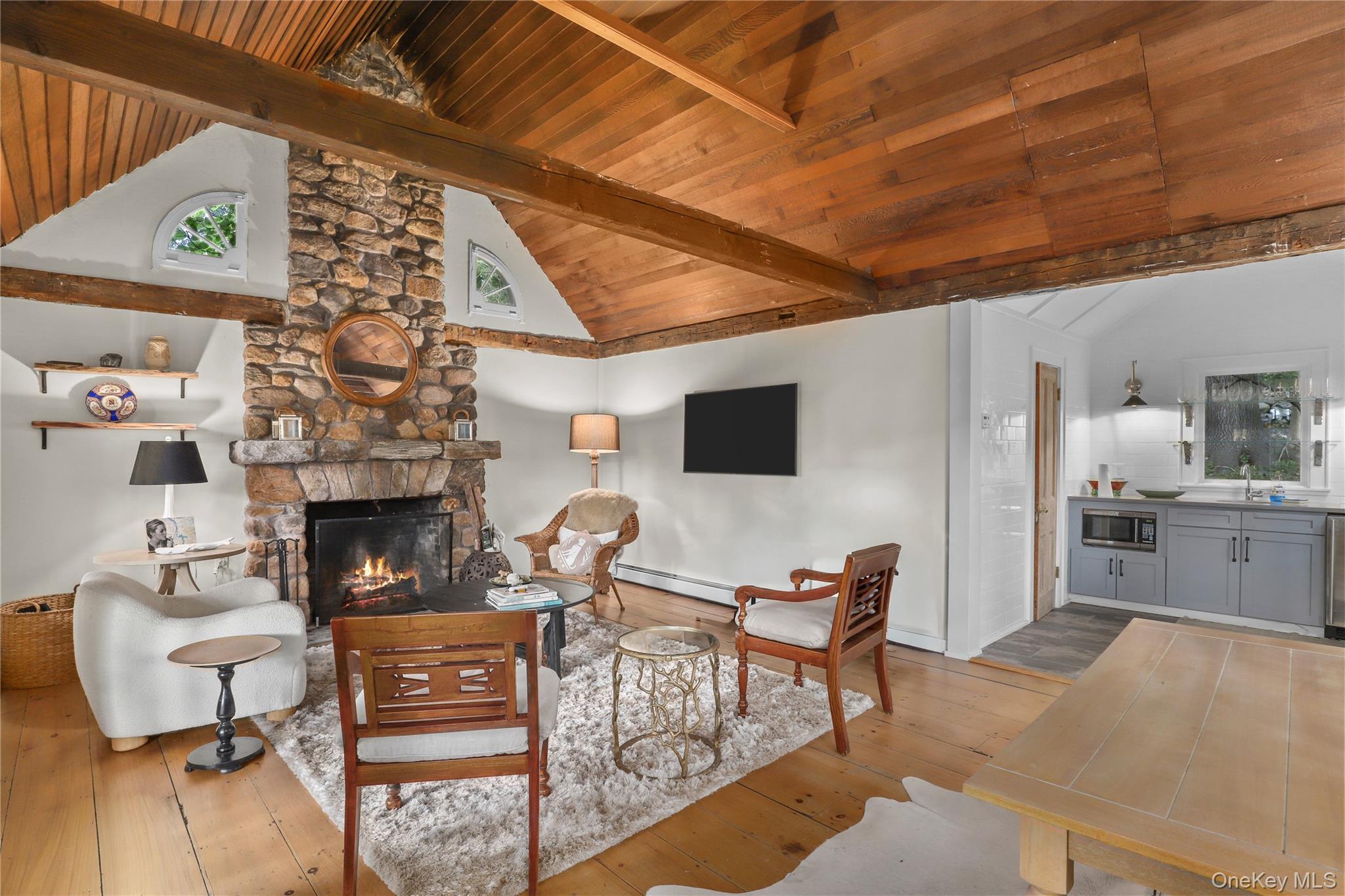 21 Katonahs Wood Road Katonah, NY 10536 - Photo 29 of 34 a living room with furniture a fireplace and a flat screen tv