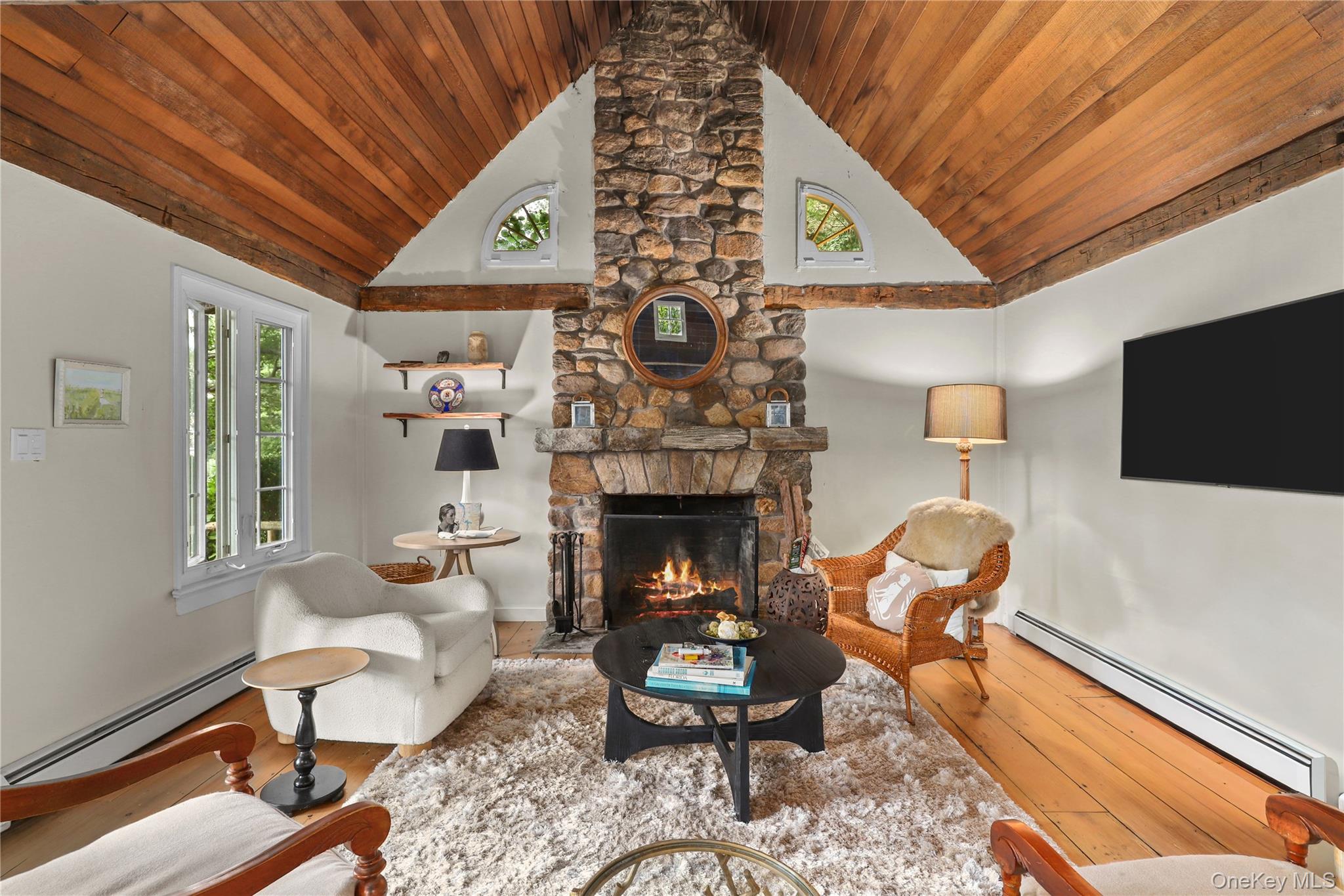 21 Katonahs Wood Road Katonah, NY 10536 - Photo 30 of 34 a living room with furniture a flat screen tv and a fireplace