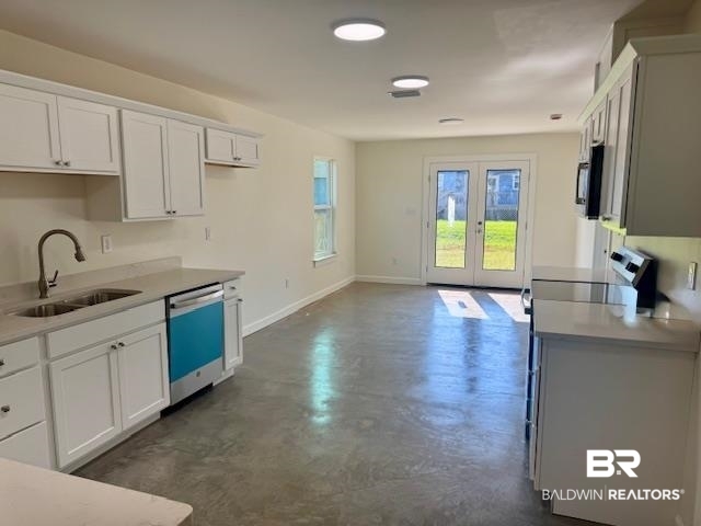 22203 6th Street Silverhill, AL 36576 - Photo 7 of 21 Kitchen with stainless appliances, white cabinetry and stone counter tops