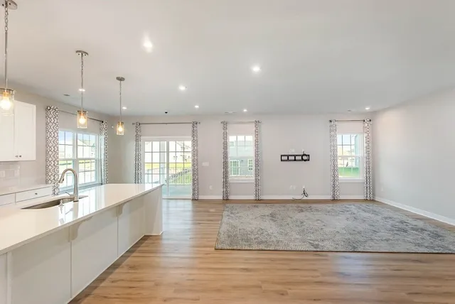a large hall with large windows and a chandelier