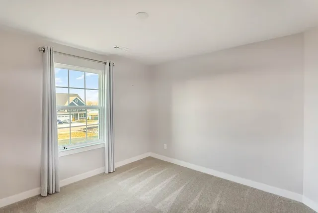 a view of an empty room and a window