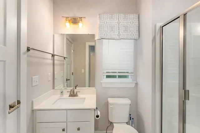 a bathroom with a sink toilet and shower