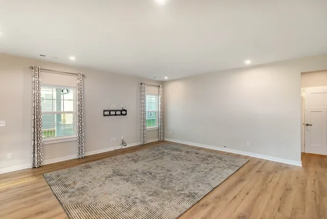 an empty room with closet and windows