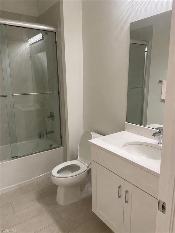 14866 Loggerhead Drive Naples, FL 34120 - Photo 11 of 16 a bathroom with a sink toilet and shower
