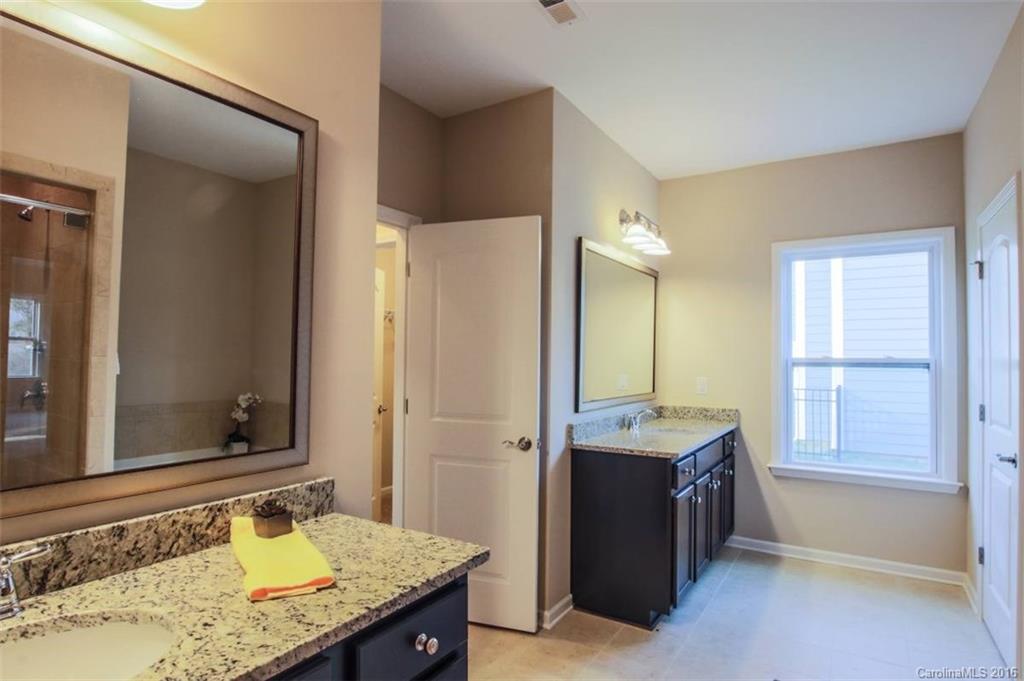 3142 Amaranth Drive, Unit 481 Fort Mill, SC 29708 - Photo 23 of 24 a bathroom with a granite countertop sink and a mirror