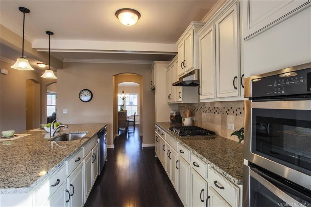 3142 Amaranth Drive, Unit 481 Fort Mill, SC 29708 - Photo 10 of 24 a kitchen with granite countertop a stove and cabinets