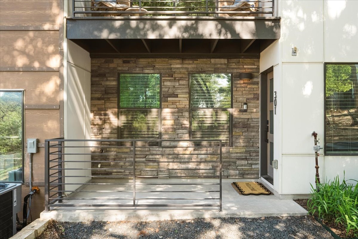 3700 Clawson Road, Unit 301 Austin, TX 78704 - Photo 12 of 35 Doorway to property featuring stone siding and a patio
