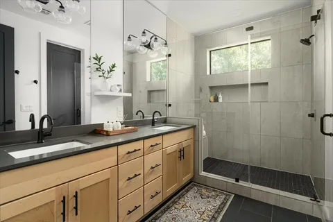a bathroom with a double vanity sink and mirror