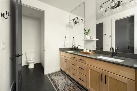 a bathroom with a granite countertop sink and a mirror