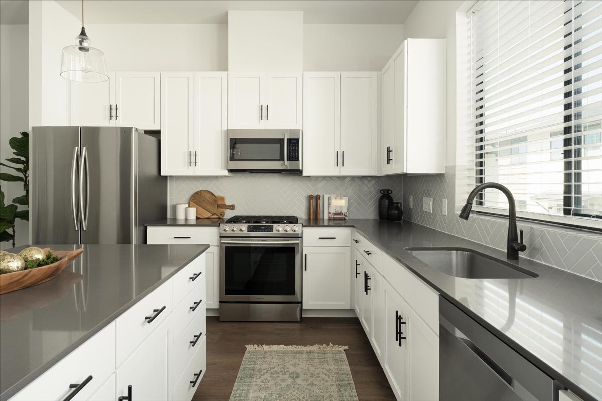 3700 Clawson Road, Unit 301 Austin, TX 78704 - Photo 6 of 35 Kitchen featuring stainless steel appliances, white cabinetry, and dark quartz countertops