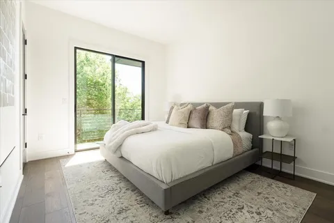 a bed sitting in a bedroom next to a window