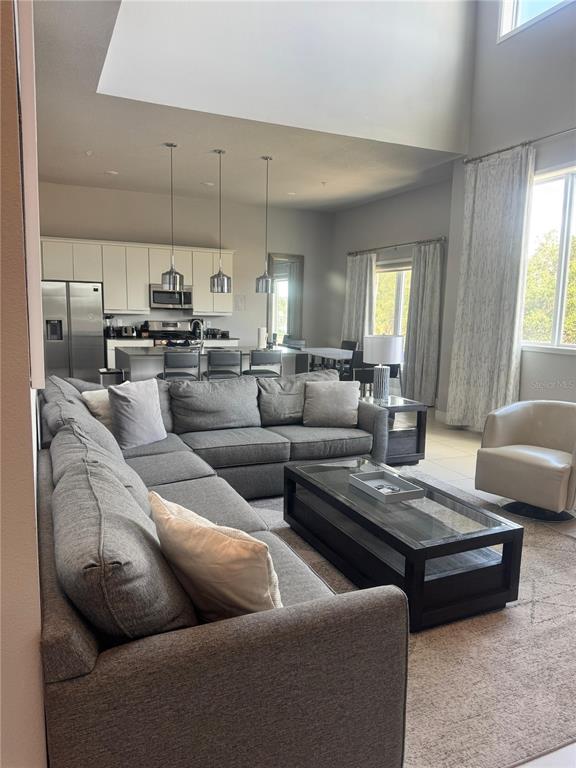 7770 Sandy Ridge Drive, Unit 210 Reunion, FL 34747 - Photo 5 of 42 a living room with furniture and a fireplace
