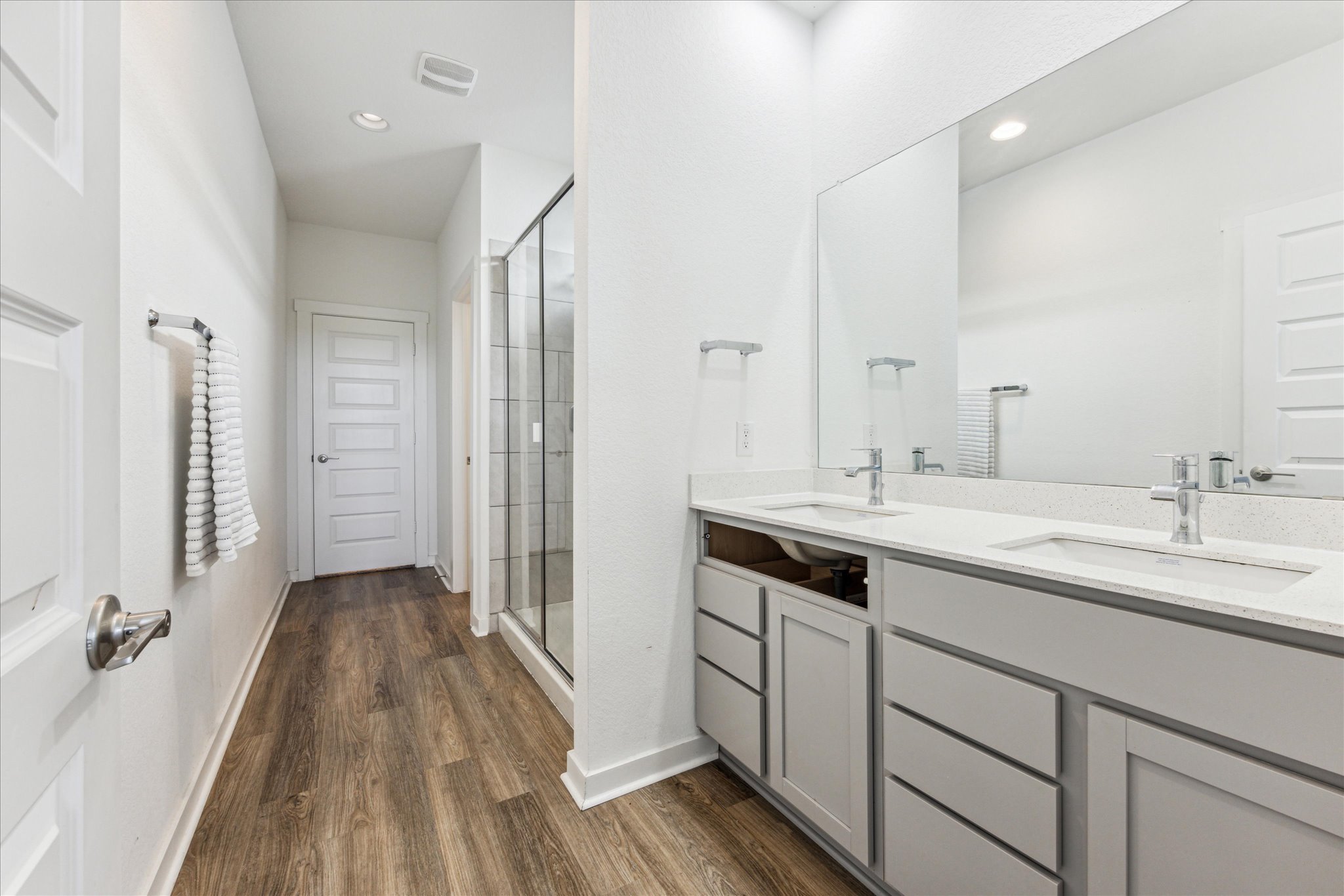 7916 Linnie Lane Austin, TX 78724 - Photo 11 of 14 a spacious bathroom with a double vanity sink and mirror