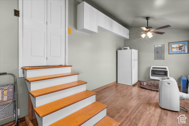 11450 Pigeon Hollow Road Spring City, UT 84662 - Photo 11 of 47 Staircase featuring heating unit, wood finished floors, electric panel, a ceiling fan, and vaulted ceiling