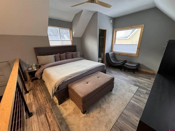 a bedroom with a bed and wooden floor