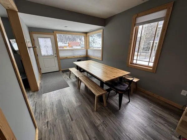 a room with wooden floor and a window