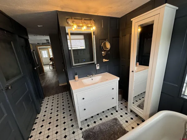 a bathroom with a sink a toilet and a mirror