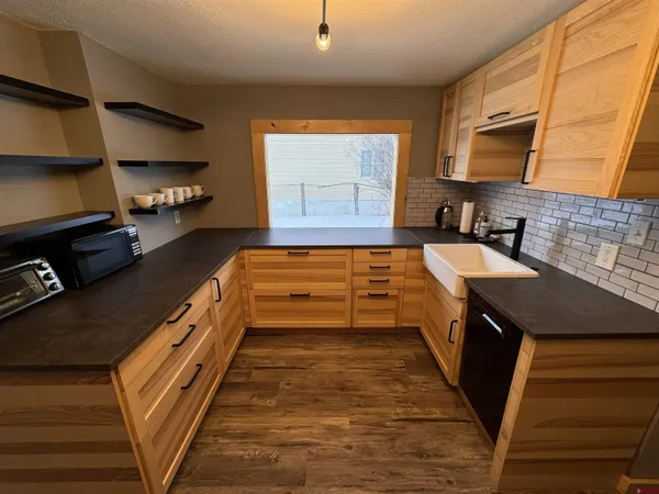 a kitchen with wooden cabinets and a sink