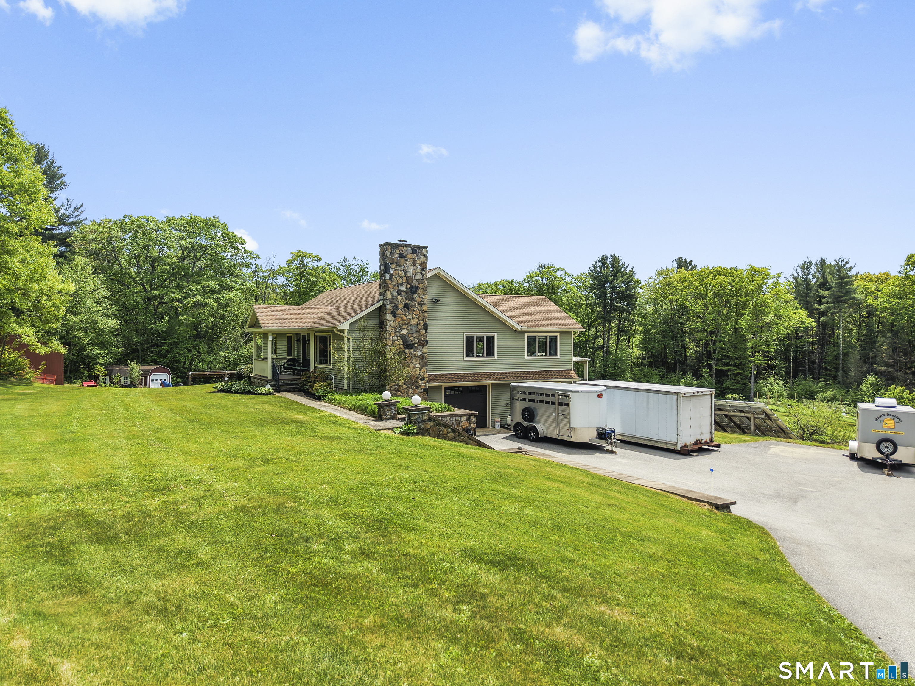 80 Holmes Road Goshen, CT 06756 - Photo 3 of 40 a view of a house with backyard porch and sitting area