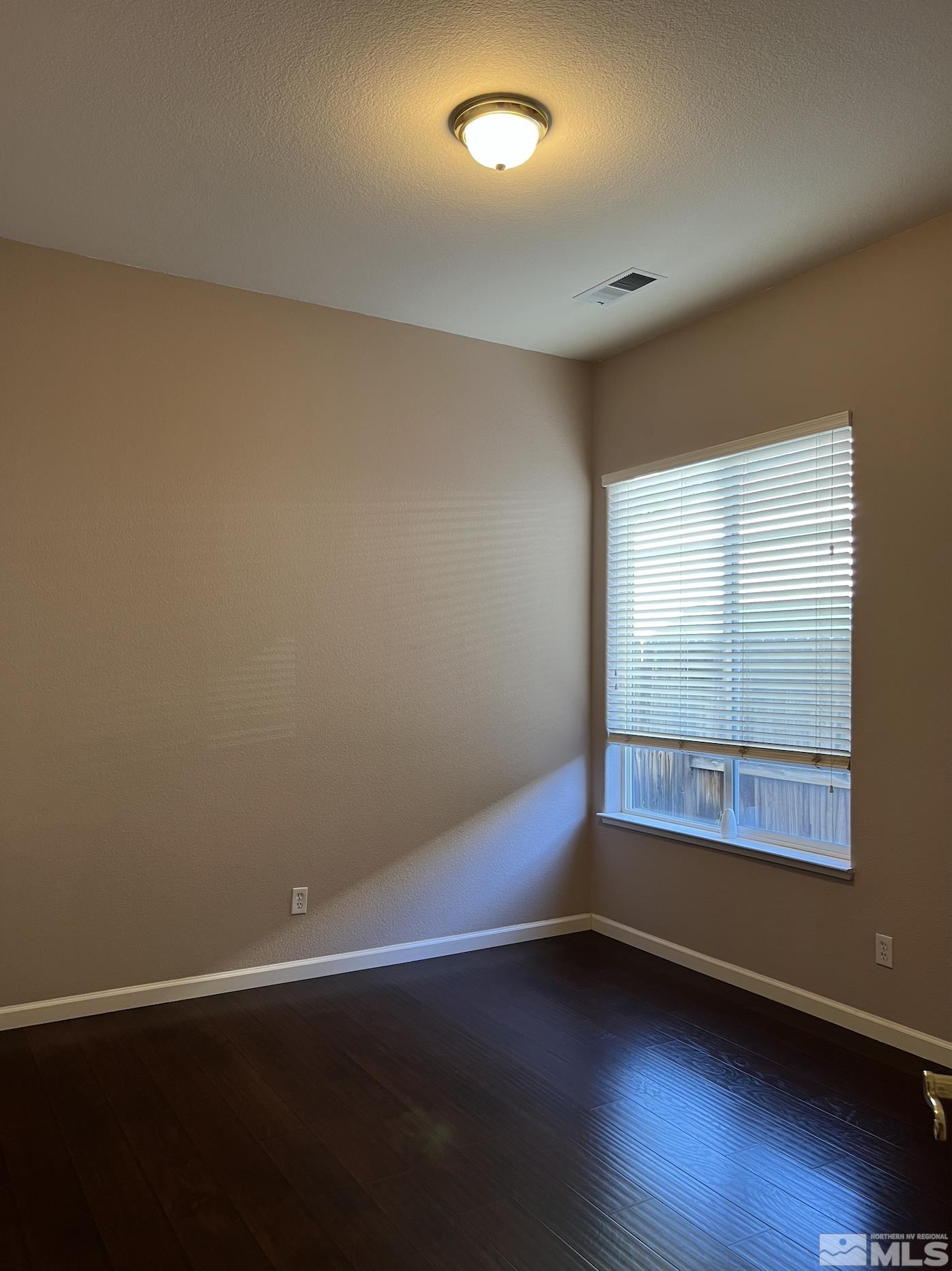1885 Beringer Way Reno, NV 89521 - Photo 19 of 29 an empty room with wooden floor and windows