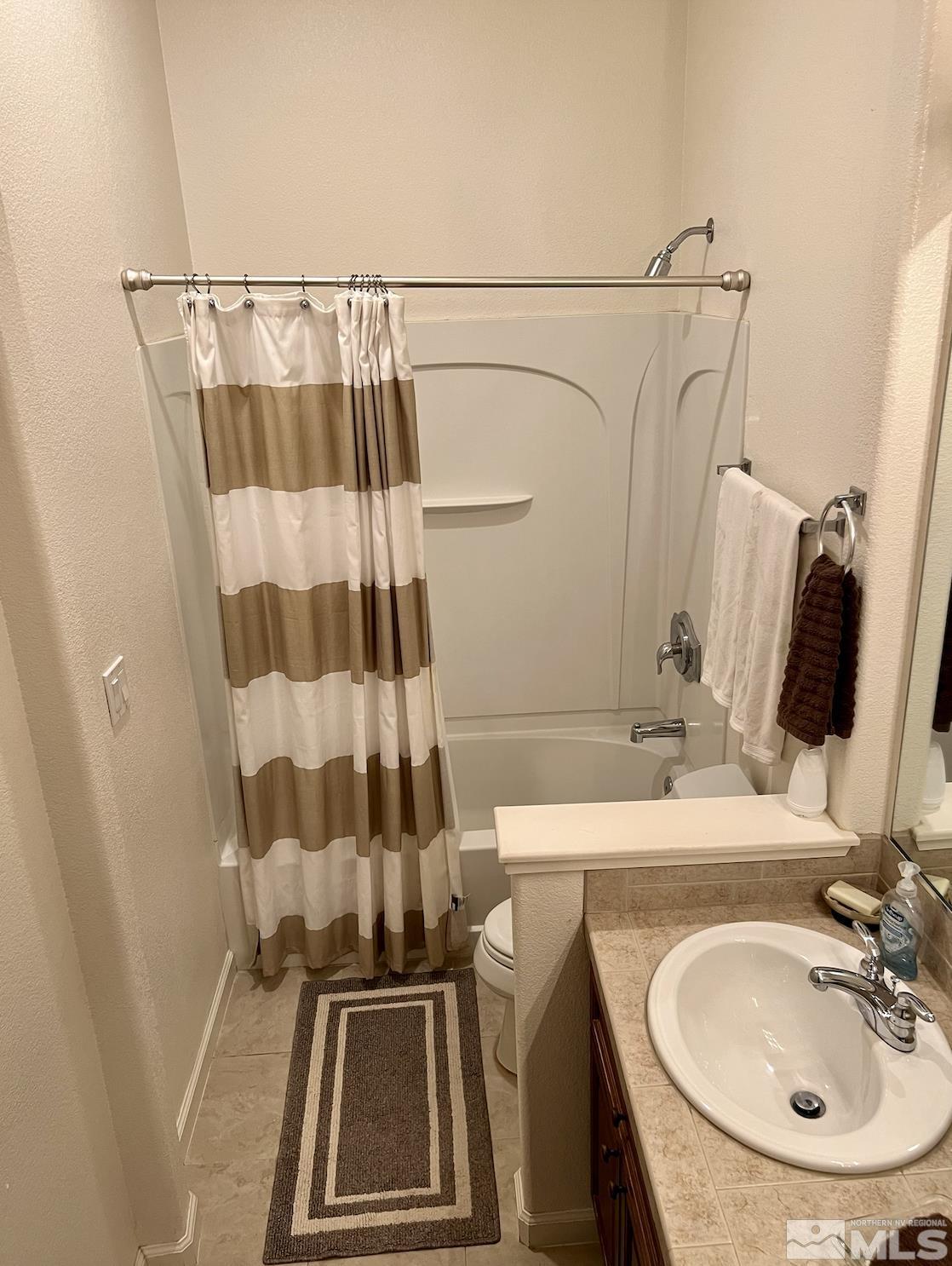 1885 Beringer Way Reno, NV 89521 - Photo 22 of 29 a bathroom with a sink a mirror a vanity and shower
