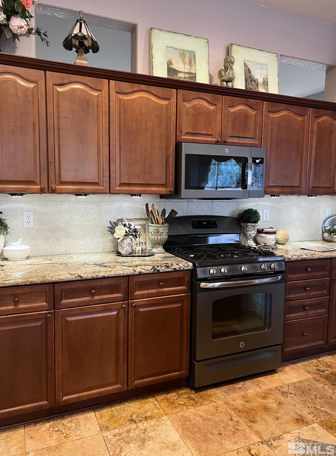 1885 Beringer Way Reno, NV 89521 - Photo 8 of 29 a kitchen with wooden cabinets and a stove top oven