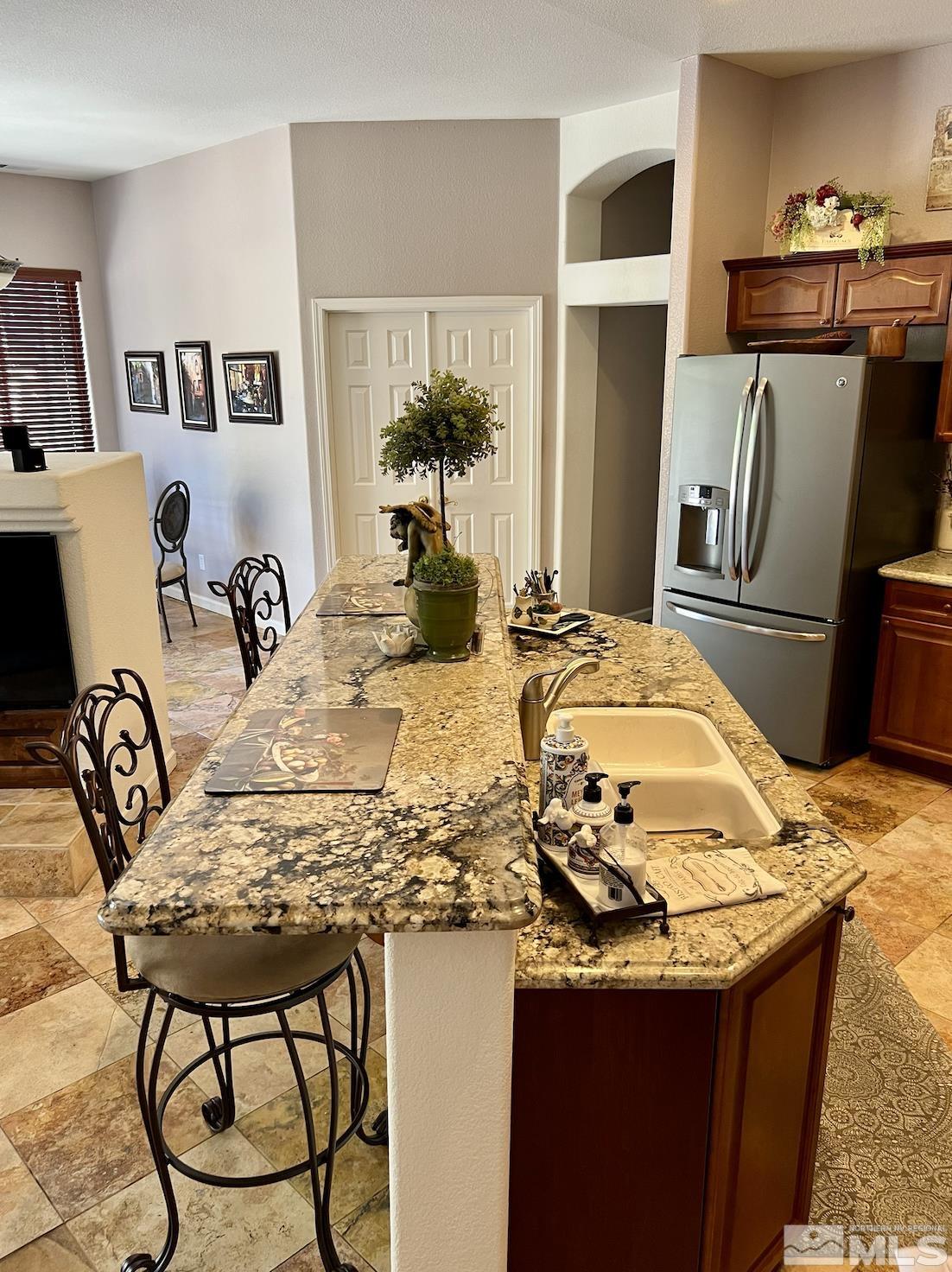 1885 Beringer Way Reno, NV 89521 - Photo 9 of 29 a view of kitchen island with appliances kitchen island granite countertop furniture and living room
