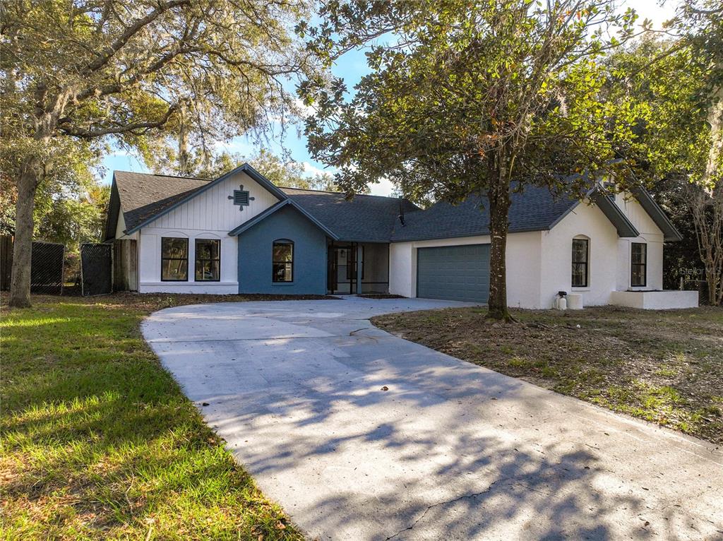 1528 Cuthill Way Casselberry, FL 32707 - Photo 1 of 1 a view of a yard in front of a house with a large tree