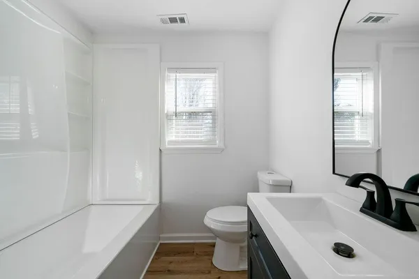 a bathroom with a sink toilet and shower