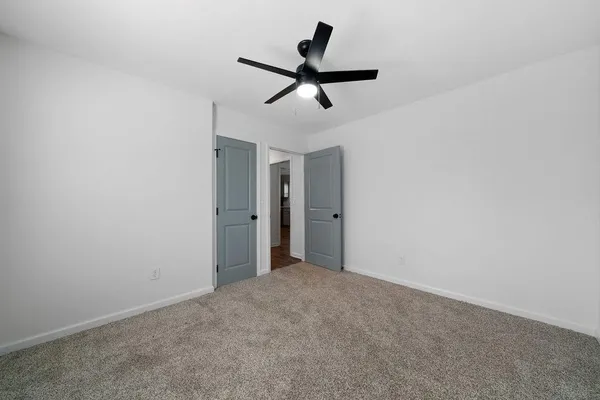 a view of empty room with ceiling fan