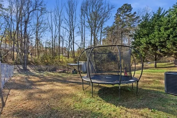 a backyard of a house with table and chairs