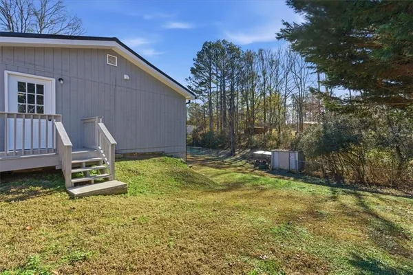 a backyard of a house with yard and outdoor seating