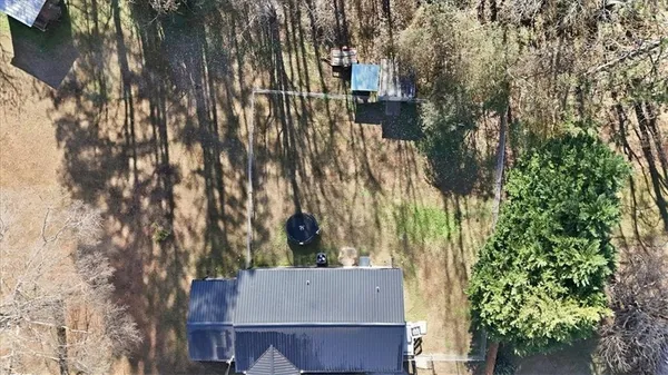 an aerial view of a house with a yard