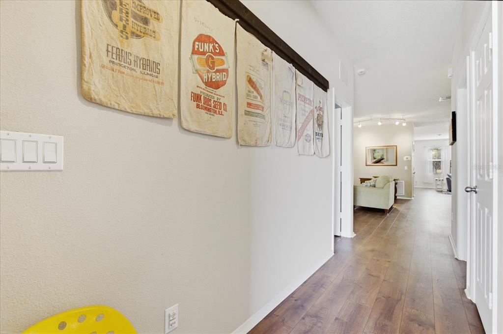 20900 Oldenburg Loop Mount Dora, FL 32757 - Photo 11 of 44 a view of a hallway with wooden floor and furniture