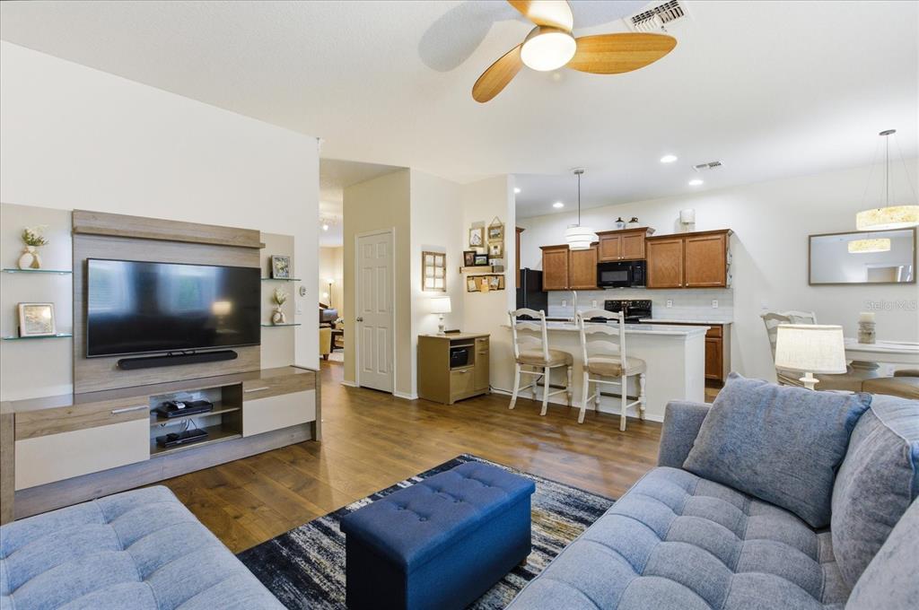 20900 Oldenburg Loop Mount Dora, FL 32757 - Photo 12 of 44 a living room with furniture kitchen view and a flat screen tv