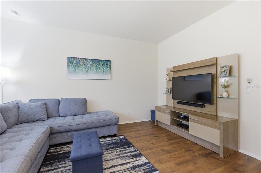 20900 Oldenburg Loop Mount Dora, FL 32757 - Photo 13 of 44 a living room with furniture and a flat screen tv