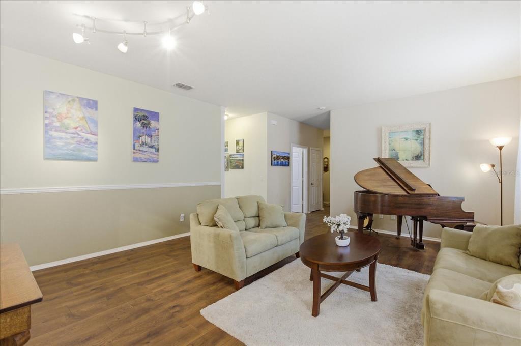 20900 Oldenburg Loop Mount Dora, FL 32757 - Photo 15 of 44 a living room with furniture and a wooden floor