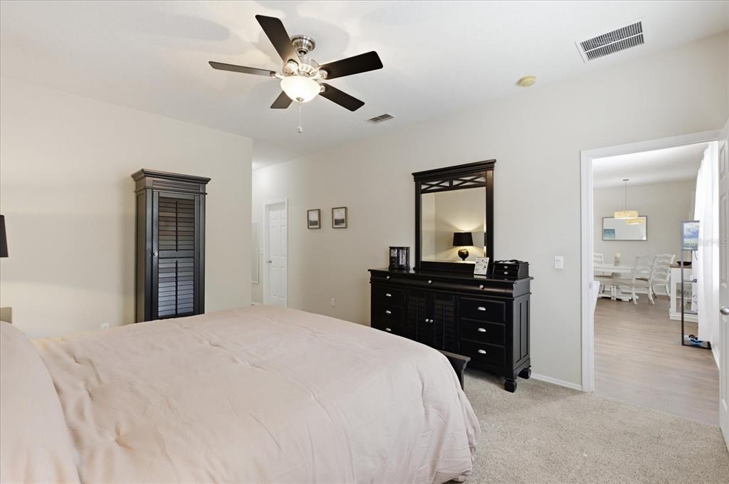20900 Oldenburg Loop Mount Dora, FL 32757 - Photo 20 of 44 a bedroom with a bed and a dresser