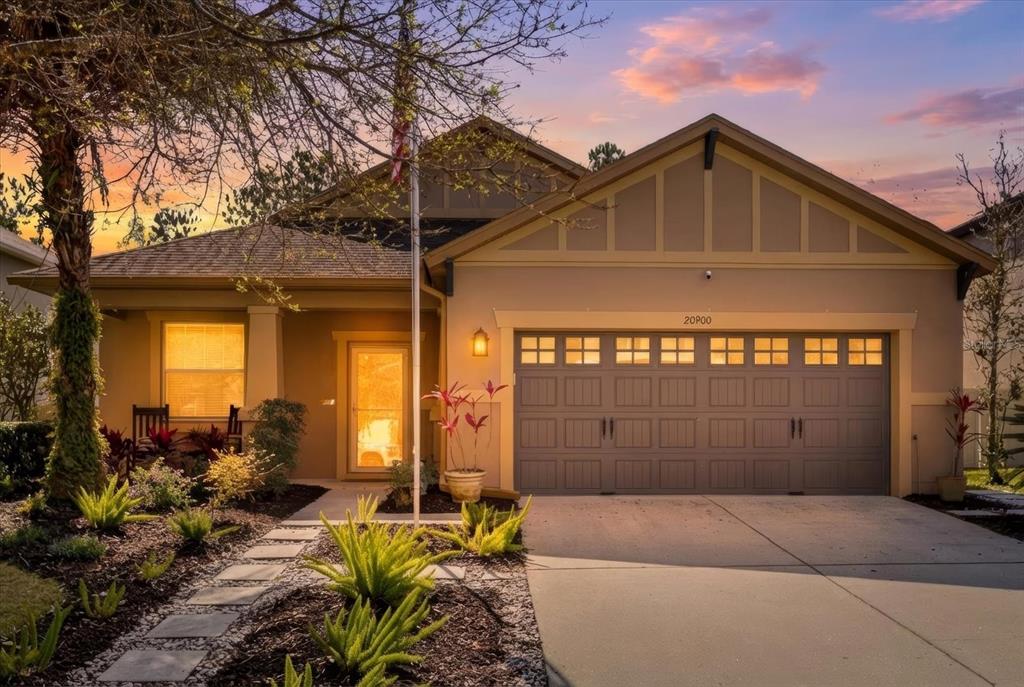 20900 Oldenburg Loop Mount Dora, FL 32757 - Photo 2 of 44 a front view of a house with garden