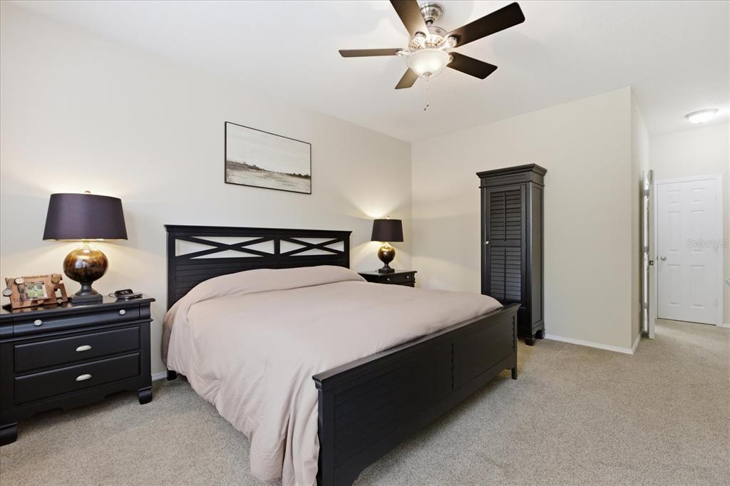 20900 Oldenburg Loop Mount Dora, FL 32757 - Photo 21 of 44 a bedroom with a bed and a ceiling fan