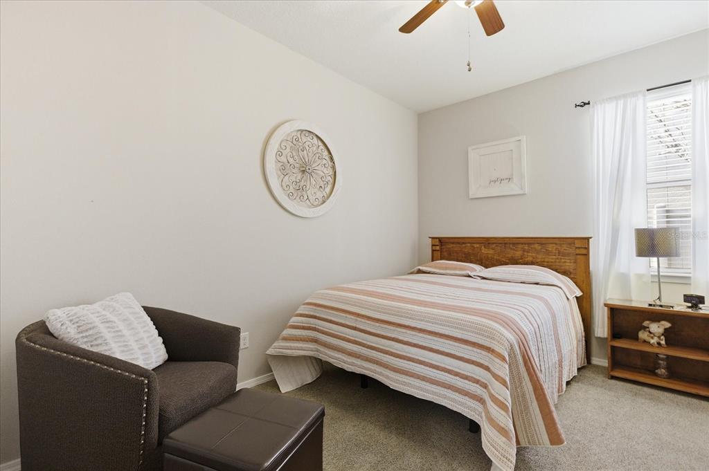 20900 Oldenburg Loop Mount Dora, FL 32757 - Photo 24 of 44 a bedroom with a bed and a chandelier