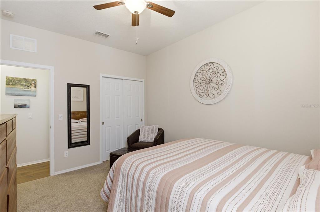 20900 Oldenburg Loop Mount Dora, FL 32757 - Photo 25 of 44 a bedroom with a bed and a chandelier