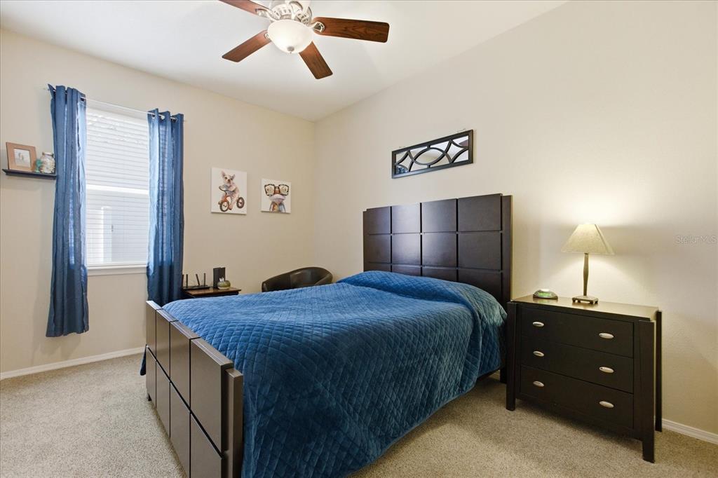 20900 Oldenburg Loop Mount Dora, FL 32757 - Photo 27 of 44 a bed room with a bed and a chandelier