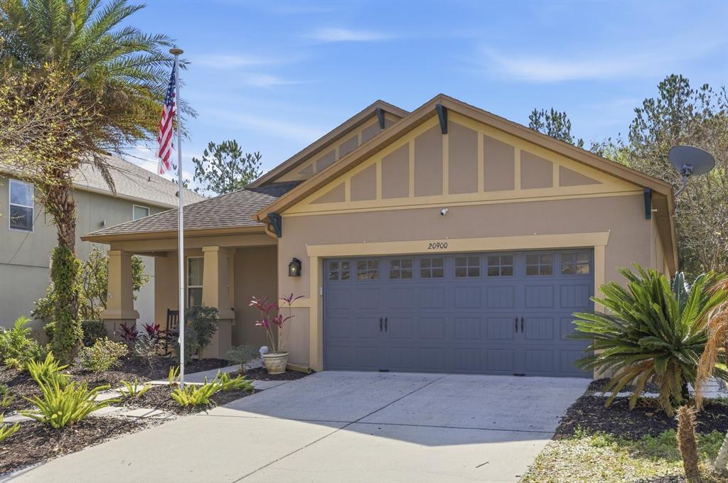 20900 Oldenburg Loop Mount Dora, FL 32757 - Photo 3 of 44 a front view of a house with a yard