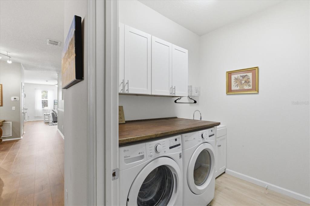 20900 Oldenburg Loop Mount Dora, FL 32757 - Photo 33 of 44 a view of a kitchen with fridge and wooden floor