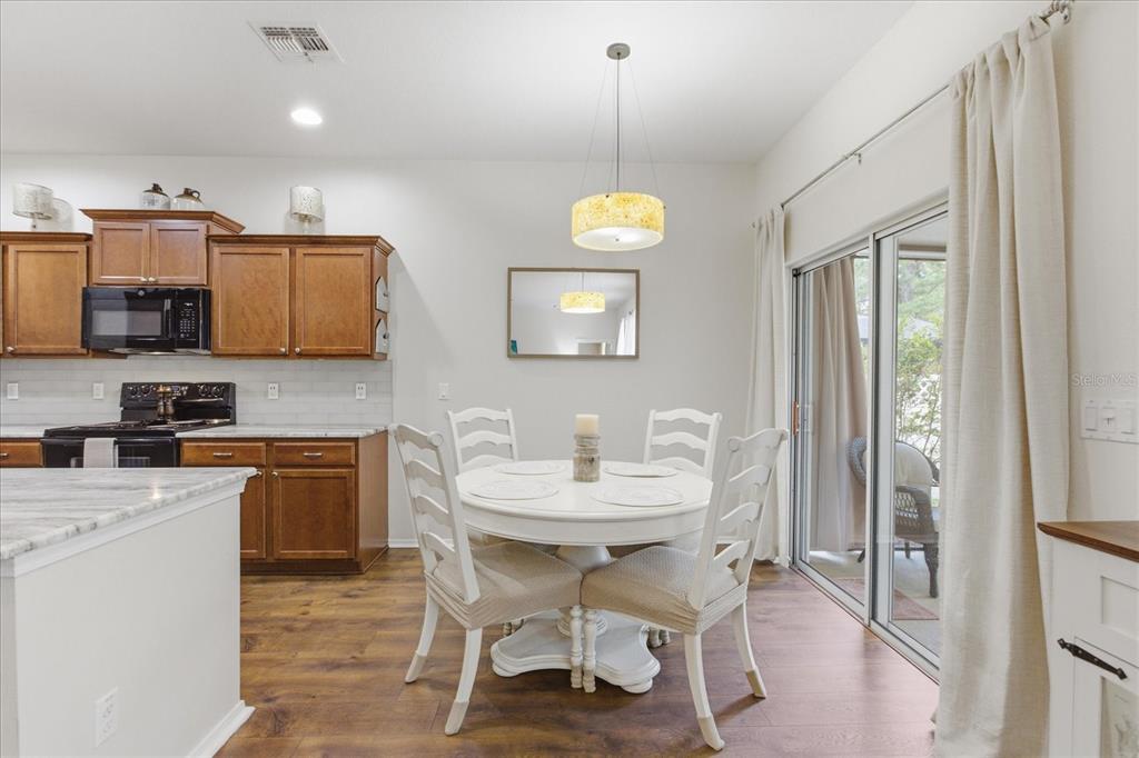 20900 Oldenburg Loop Mount Dora, FL 32757 - Photo 10 of 44 a kitchen with stainless steel appliances granite countertop a sink a stove and a refrigerator